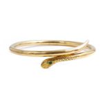 An early 20th century gold emerald and diamond set serpent or snake bangle,