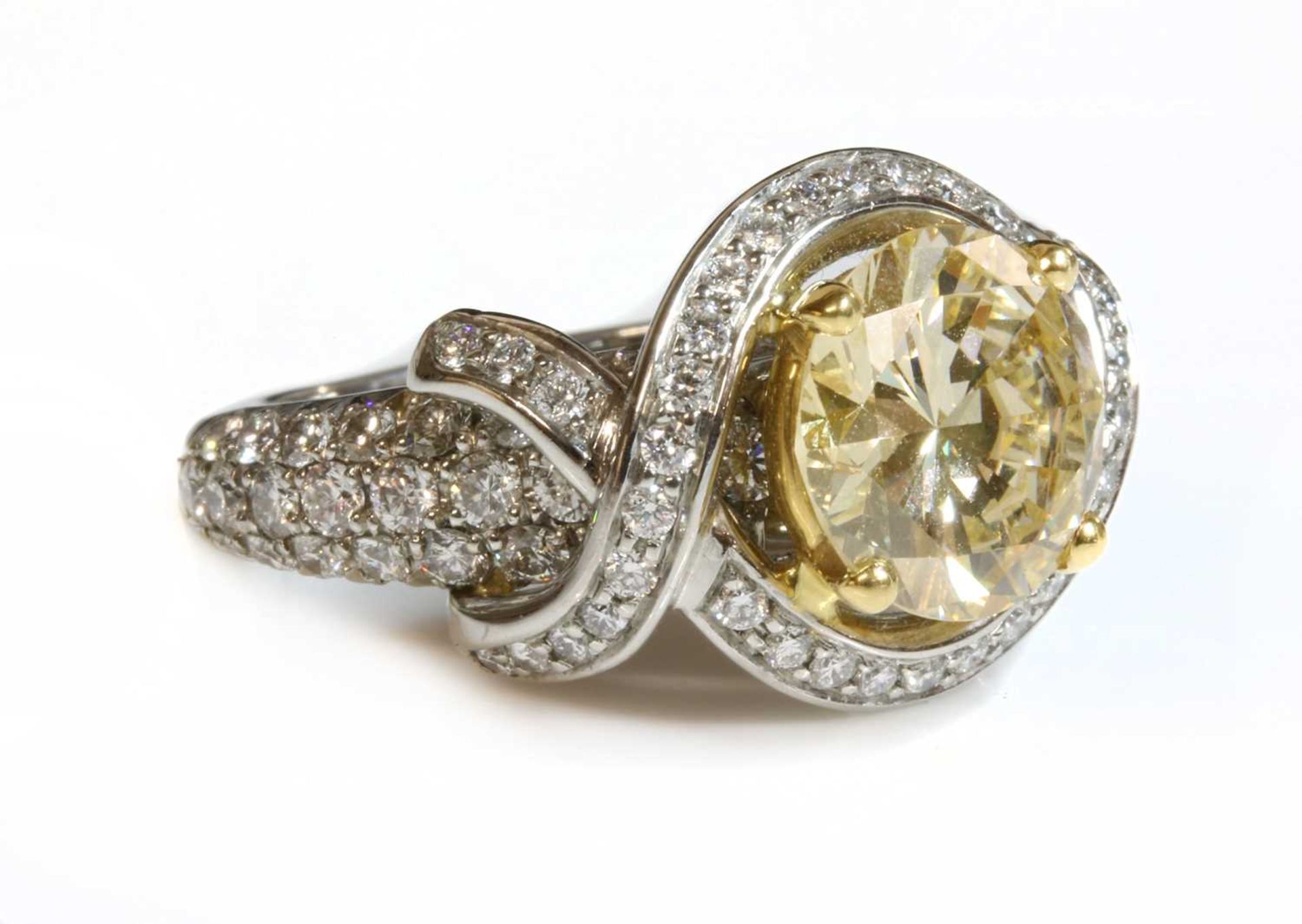 A single stone fancy light yellow diamond halo cluster ring,