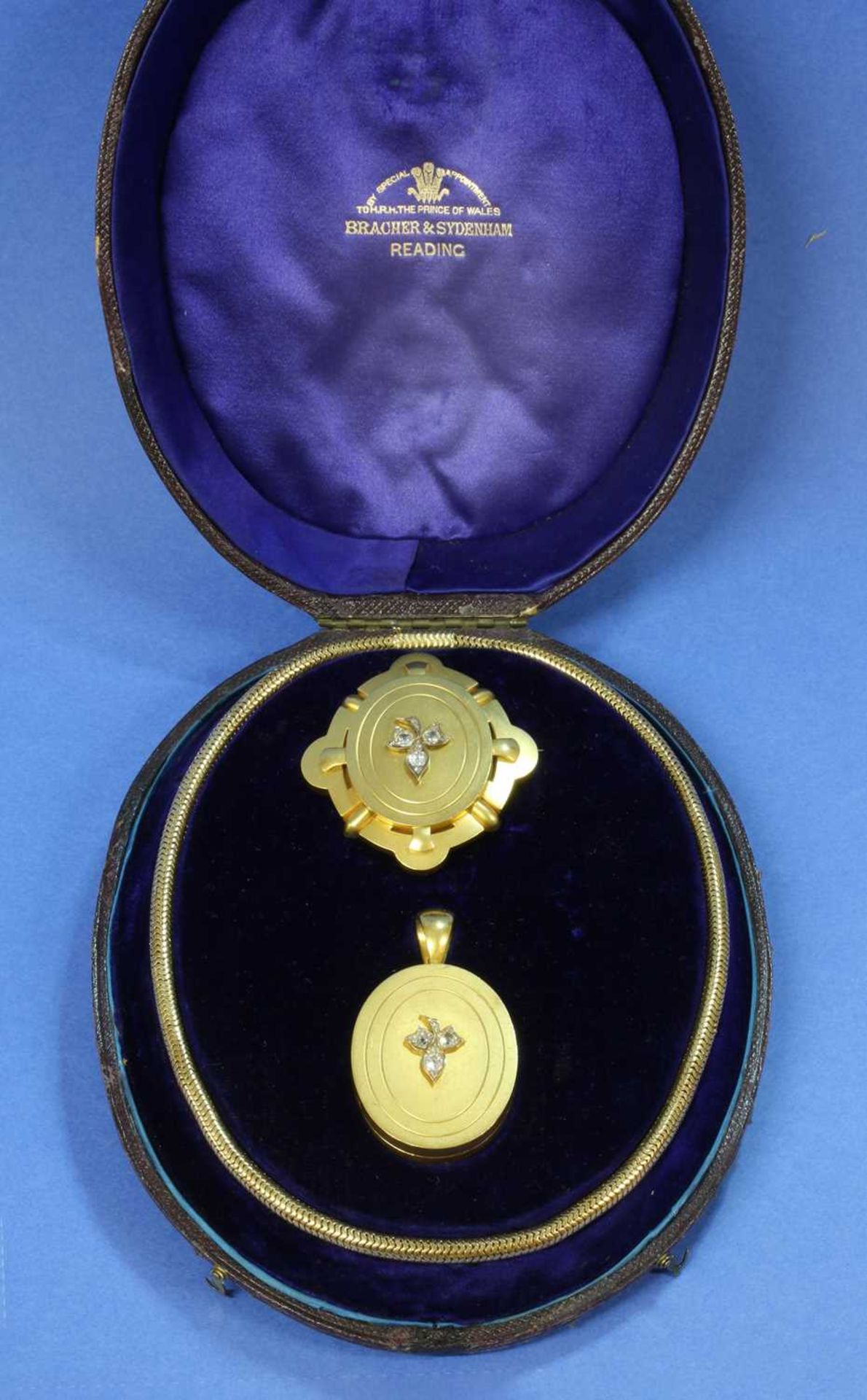 A cased Victorian gold diamond set locket, chain and brooch suite, by Bracher and Sydenham, Reading,