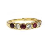An 18ct ruby and diamond half eternity ring,