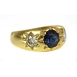 A three stone sapphire and diamond gypsy ring,