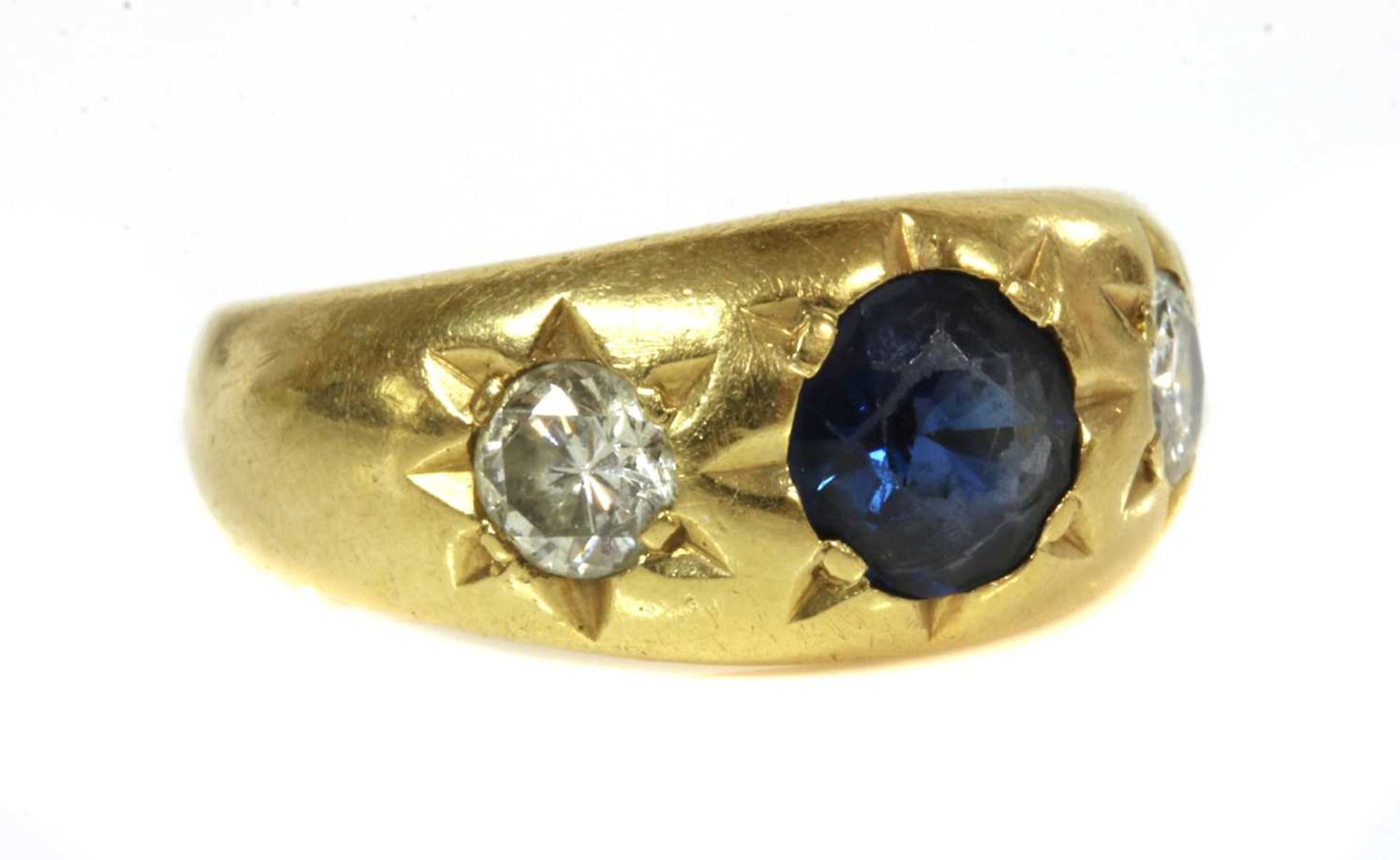 A three stone sapphire and diamond gypsy ring,