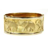 An Italian two colour gold elephant design hinged bangle,