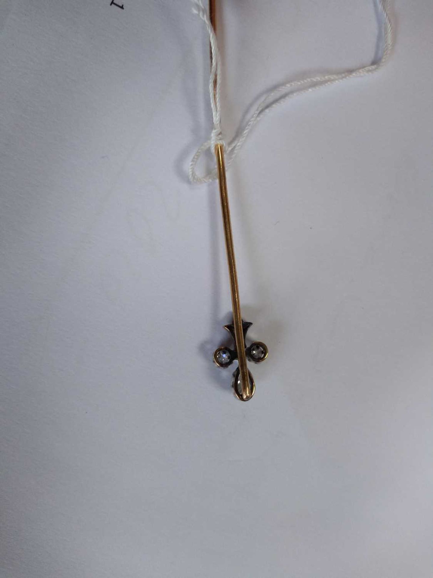 A cased diamond set fleur-de-lys stick pin, early 20th century, - Image 3 of 5