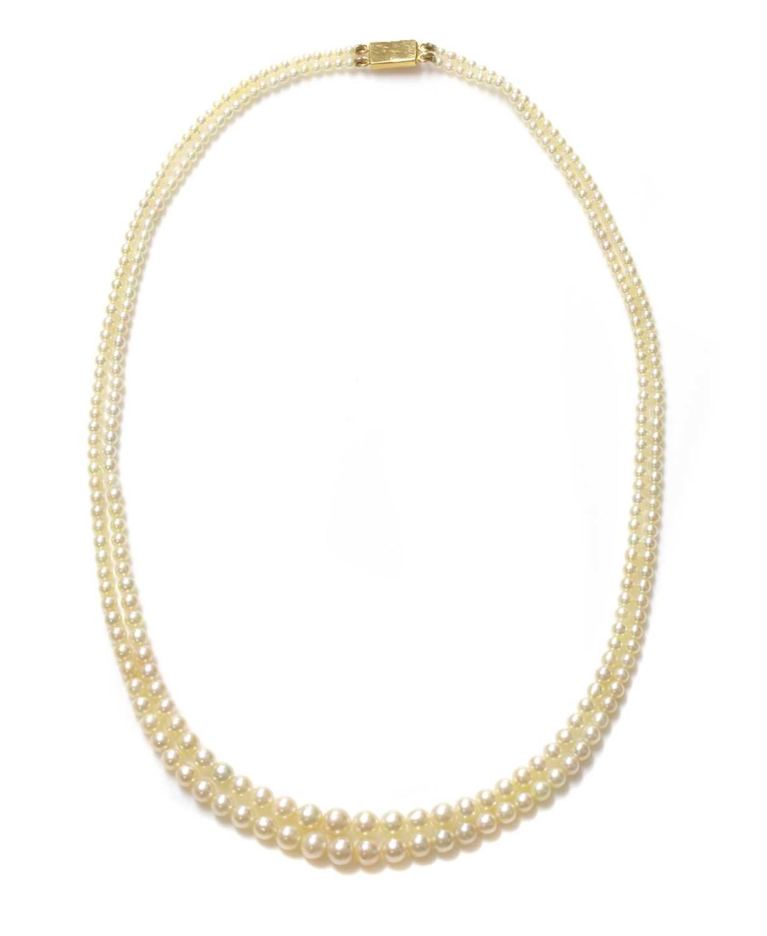 A cased two row graduated natural pearl necklace,