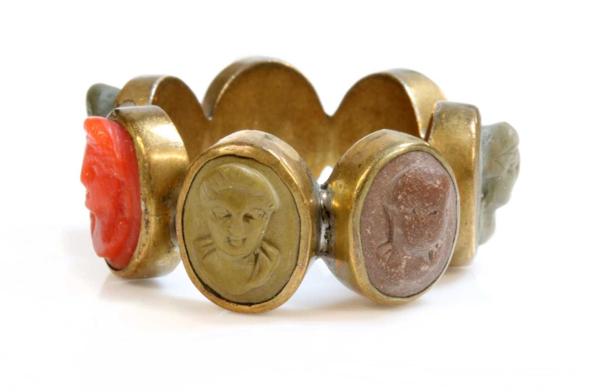 A late Georgian gilt metal specimen lava and coral cameo ring,
