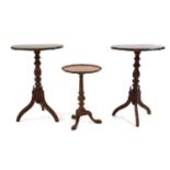 A pair of Victorian grained pine tripod tables,