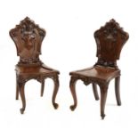 A pair of Victorian mahogany hall chairs,