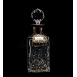 A silver mounted decanter and three wine labels,