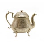 A Persian engraved white metal teapot,