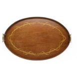An Edwardian fiddle cut mahogany oval tea tray,