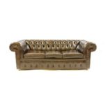 A brown leather three seater Chesterfield sofa,