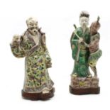 A 19th century Chinese porcelain figure group depicting an elder with tribesman beside,