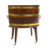 A George III oval brass bound mahogany wine cooler,