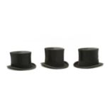 Three various moleskin top hats,