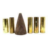 Four brass commemorative shellcases and an iron shell cone.