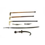 Three Eastern daggers in scabbards, a sword blade and three walking sticks