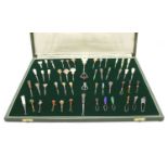 A cased collection of button hooks with various handles,