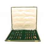 A cased collection of button hooks with various handles,