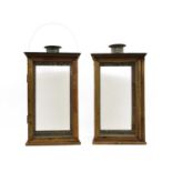 A pair of wooden framed garden lanterns with tin-plate tops and funnels,