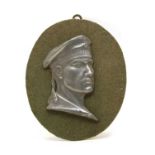 A pewter portrait plaque depicting a WW2 German sailor wearing uniform