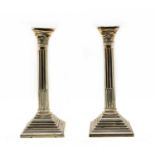 A pair of George V silver classical column candlesticks,