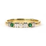 An 18ct gold diamond and emerald three stone ring,