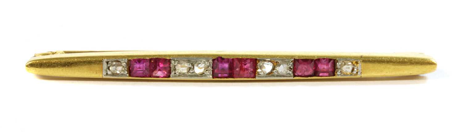 An Art Deco, gold, ruby and diamond bar brooch,