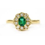 An 18ct gold emerald and diamond cluster ring,