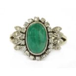 A white gold emerald and diamond ring,