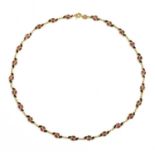 A gold ruby and sapphire necklace,