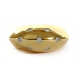 A gold diamond bombé ring,