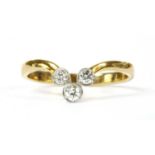 A gold three stone diamond wishbone ring,