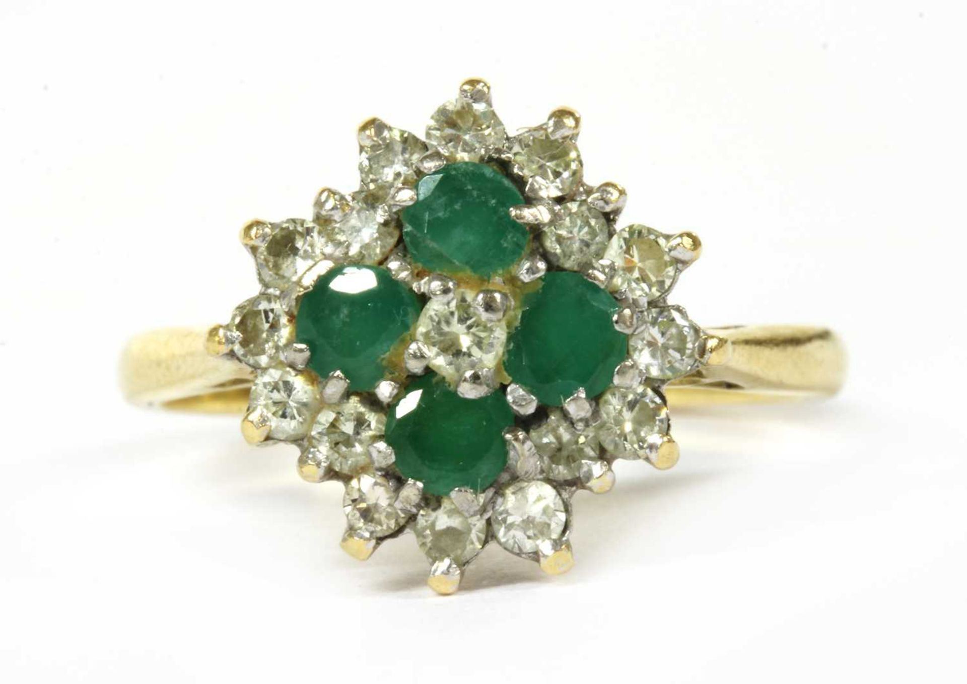 A gold diamond and emerald quatrefoil cluster ring,