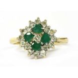 A gold diamond and emerald quatrefoil cluster ring,