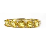 A gold five stone yellow sapphire ring,