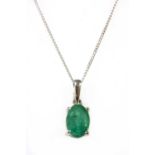 A white gold single stone emerald pendant,