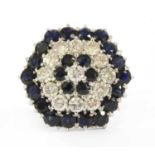 A white gold diamond and sapphire target cluster ring,