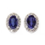 A pair of white gold sapphire and diamond cluster earrings,