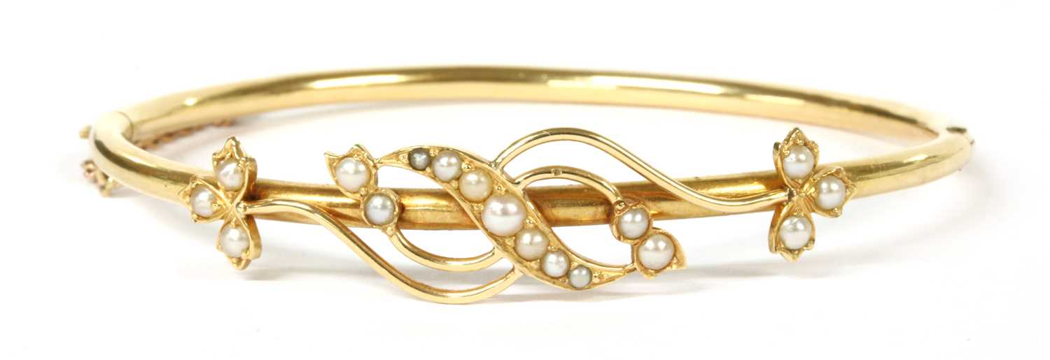A Victorian gold split pearl hinged bangle,