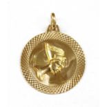 A gold circular Nefertiti pendant,
