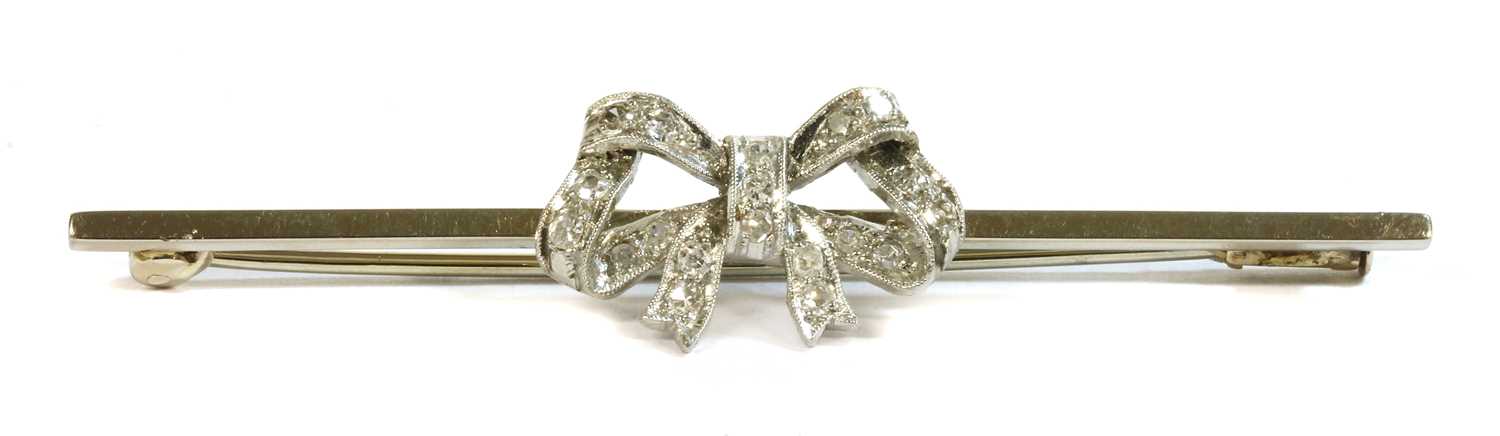 A white gold diamond set bow brooch, c.1925,