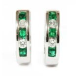 A pair of 18ct white gold emerald and diamond oval hoop earrings,