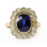 An early 20th century gold synthetic sapphire and diamond cluster ring,