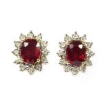 A pair of gold ruby and diamond cluster earrings,