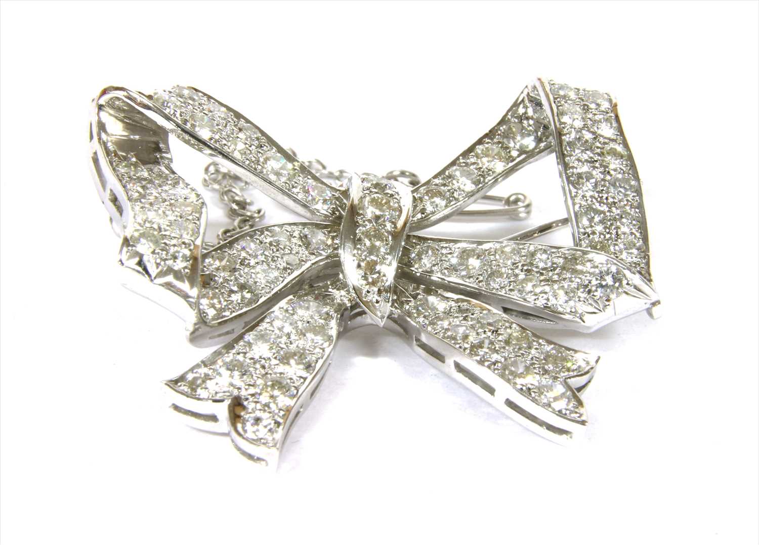 A diamond set bow brooch,