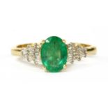 A gold emerald and diamond ring,