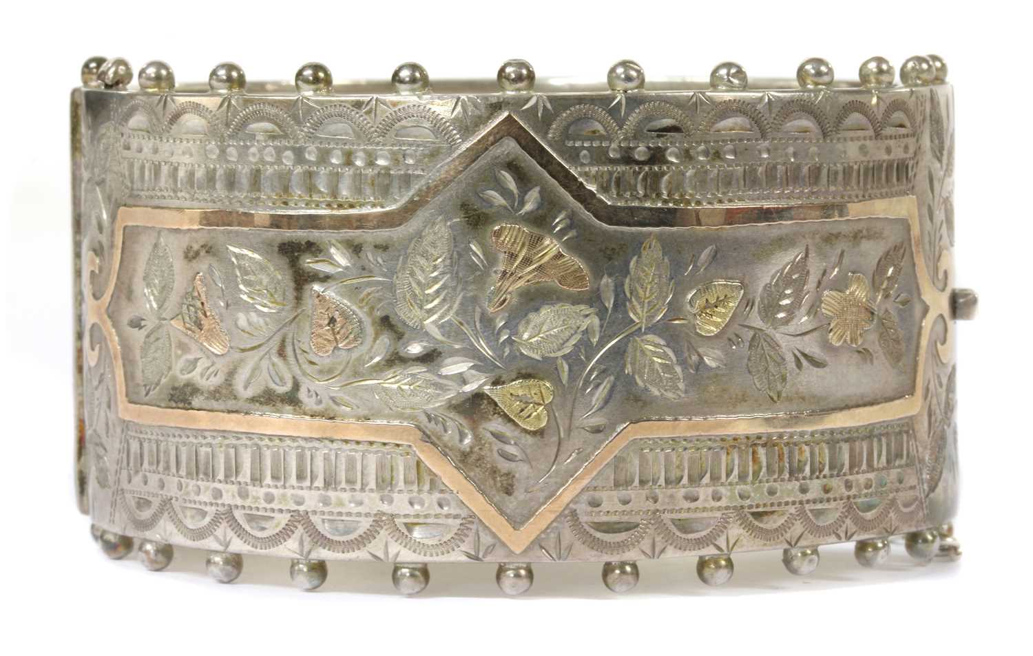 A late Victorian sterling silver hinged bangle,