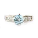 A platinum blue topaz and diamond ring