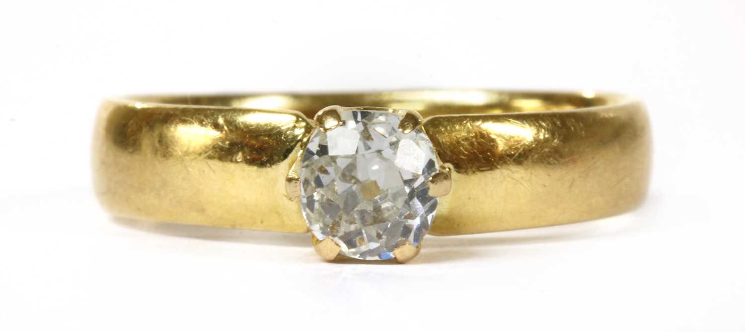 A gold single stone diamond ring,